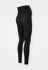 Svarta gravidleggings med hög midja, tillverkade av mjukt och stretchigt tyg, med en slät textur och en figurnära siluett.