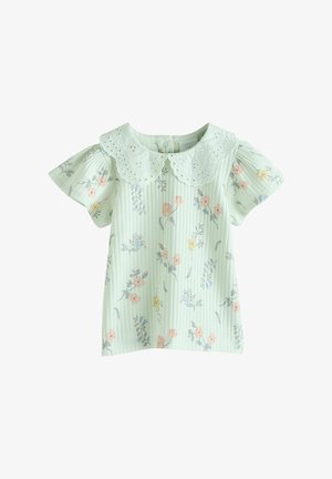 Light green patterned top with a lace-trimmed collar. Features short, puffed sleeves and floral prints in pink, blue, and yellow.