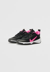 Black athletic shoes featuring pink accents, mesh and synthetic upper, rounded toe, and textured sole for grip. Nike logo prominently displayed.