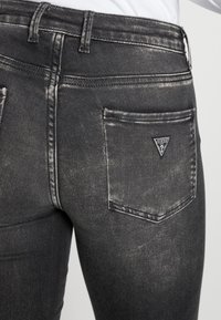 Guess Farkkuleggingsit - black denim
