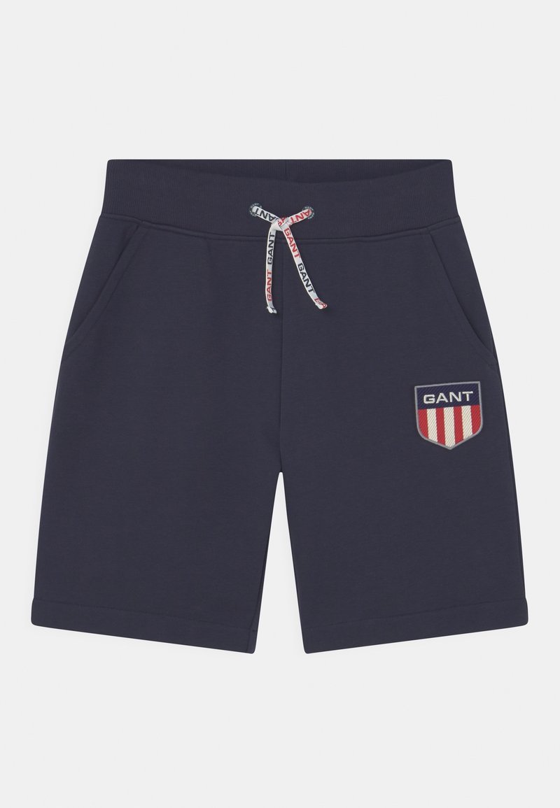 Hosen in Marineblau aus Baumwolle, mit einem Kordelzug mit GANT-Branding, seitlichen Taschen und einem gestickten Logo-Patch mit Streifen.