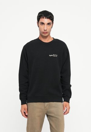 Black sweatshirt with round neckline, ribbed cuffs, and hem. Features white embroidered branding on the left chest. Soft, cotton blend material.