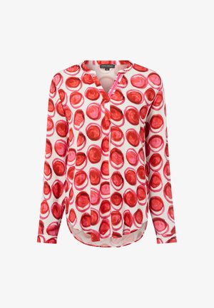 Long-sleeve blouse with round neckline, white base, and red circular pattern throughout.