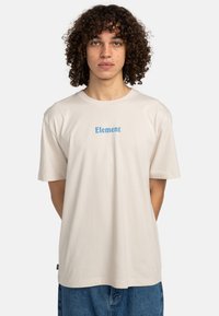 Cream-colored cotton t-shirt with short sleeves, featuring a blue "Element" logo centered on the chest, relaxed fit, and rounded neckline.