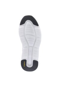 White sneaker sole with black tread on heel and toe and a yellow Goodyear logo on the heel tread.