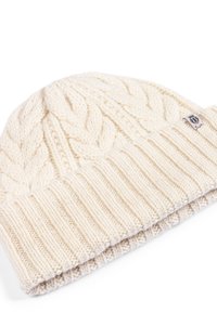 Knitted cream beanie featuring a textured cable pattern on the upper and ribbed detail on the brim; fabric appears soft and thick.