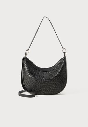 Black woven handbag with a curved shape, a zip closure, and a long adjustable strap. Textured finish enhances its surface detail.