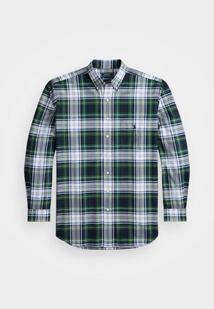 Camisa de manga longa xadrez em verde escuro, azul-marinho, branco e amarelo. Apresenta um colarinho abotoado e um bolso no peito com um logotipo. Material em algodão.