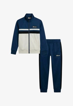 Veste zippée marine et blanche avec poches avant et joggings assortis marine avec bandes latérales noires et logos ellesse sur les deux pièces.