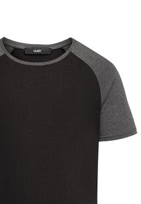 Black short-sleeve T-shirt with gray raglan sleeves, round neckline, and smooth texture. Label reads "HUMY."