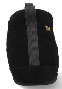 Black slip-on shoe with a soft suede texture, a gray elastic strap at the back, and a rubber sole. Features a small gold logo on the side.