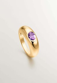 Anillo de oro con un diseño suave y redondeado que presenta una piedra de amatista central, exhibiendo una superficie brillante y un acabado pulido y elegante.