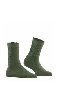 Zielone skarpety o teksturze z diamentowym wzorem, z falbaną na górnej krawędzi, wykonane z miękkiego materiału, zaprojektowane z myślą o komforcie i dopasowaniu.