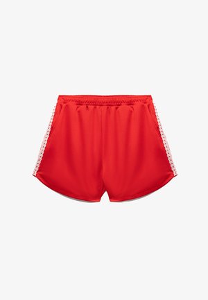 Rode sportieve shorts met een elastische tailleband, voorzien van witte kant langs de zijkanten en een gladde, ademende stoftextuur.