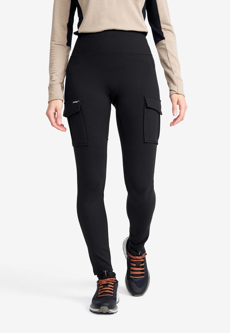Svarta leggings med hög midja, med två stora cargofickor på sidorna. Slät textur, elastiskt tyg och tapered ben-design.