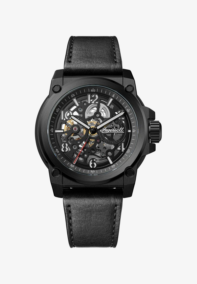 Svart automatisk klocka med transparent urtavla som visar intrikata kugghjul, silver- och guldaccenter samt ett svart läderarmband.