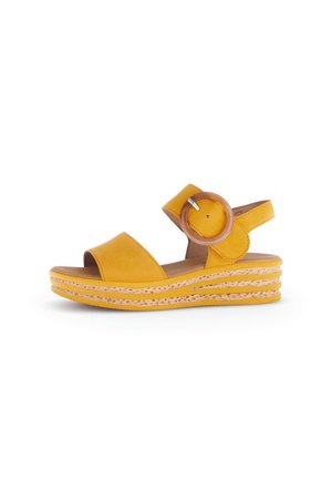 Yellow leather wedge sandal with an open toe, adjustable ankle strap featuring a circular buckle, and a layered espadrille-style sole.