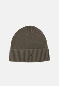 Olive green knit beanie with a ribbed texture, featuring a folded brim and a small logo patch in red, white, and blue.