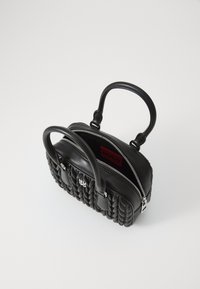 Black leather handbag with woven texture, dual top handles, zip closure, and a red interior label featuring "HUGO." Compact design with accented details.