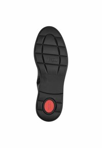 Semelle en caoutchouc noir avec un motif de grip texturé, accent rouge circulaire et logo de la marque en relief. Taille indiquée comme 37.