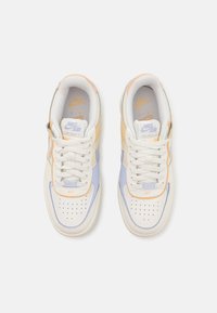 Zapatillas Nike Air Force 1 en blanco, naranja claro y azul pastel. Presentan cuero texturizado, puntera perforada y cordones planos.