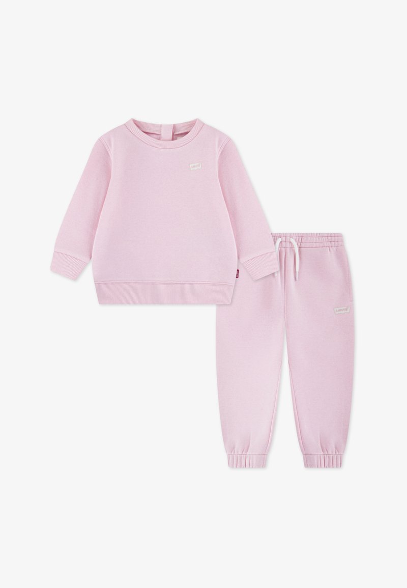 Rosa Sweatshirt- und Jogginghose-Set für Kleinkinder aus weichem Stoff. Das Sweatshirt hat einen Rundhalsausschnitt und gerippte Bündchen; die Hose ist mit einem elastischen Bund ausgestattet.