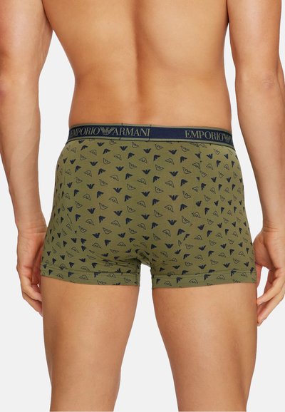 Men's boxer briefs in olive green, featuring a repeating dark blue pattern. Elastic waistband with "Emporio Armani" branding. Soft fabric finish.