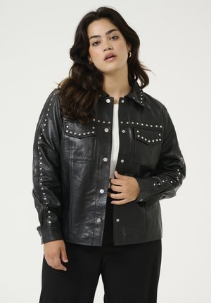 Black leather jacket featuring silver studs on shoulders and pockets, with a collared neckline and button closures, designed with a relaxed fit.