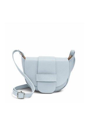 Petit sac bandoulière en cuir bleu clair avec un rabat arrondi et une sangle réglable reposant sur une surface blanche.