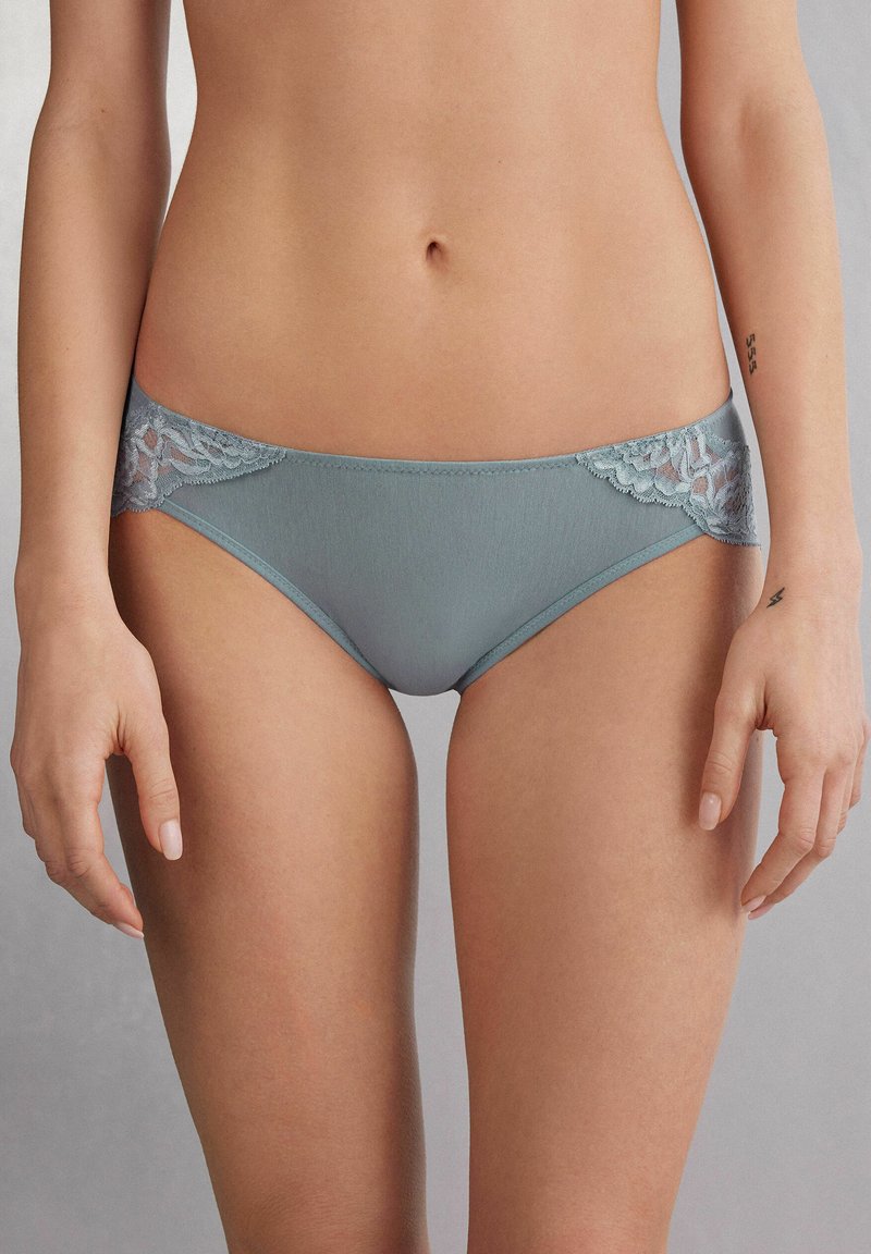 Lichtblauwe ondergoed met kanten accenten aan de zijkanten, met een gladde textuur en een klassieke slipstijl, met een comfortabele, laag uitgesneden pasvorm.