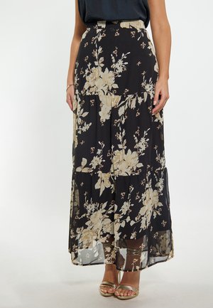 Gonna maxi floreale in chiffon nero con motivi di fiori beige e bianchi, caratterizzata da un design a strati e una vita elastica.