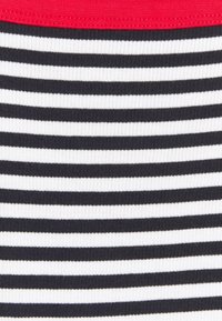 Randigt tyg med växlande tjocka svarta och vita horisontella ränder samt ett fast rött elastiskt midjeband. Texturerad ribbad mönster.