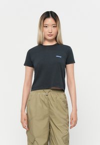 Black cropped t-shirt in cotton with a crew neckline and short sleeves, featuring a small blue "obey" logo on the left chest.