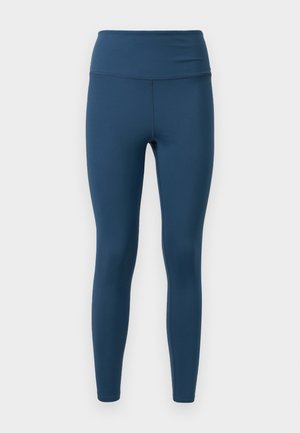 Blauwe legging gemaakt van rekbaar materiaal. Ontwerp met hoge tailleband, zachte textuur en strakke pasvorm met minimale naden. Geen patronen of accenten.