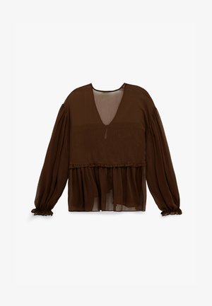 Bruine transparante blouse met lange mouwen, V-hals en een ruches taille. Voorzien van elastische manchetten en een gelaagde onderkant voor extra textuur.