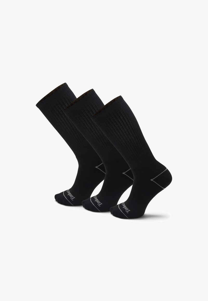 Schwarze kniehohe Socken mit gerippter Struktur, verstärkter Zehen- und Fersenpartie, einem kontrastierenden goldenen Streifen am oberen Rand und Markenlogo auf der Sohle.