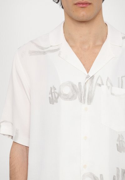 Short-sleeve white shirt featuring gray printed text and images, with a classic collar, single chest pocket, and button detailing.