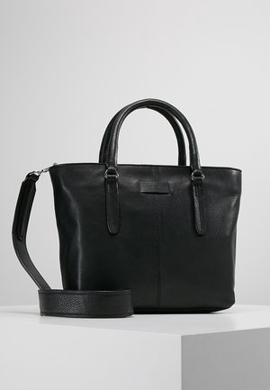 Black leather handbag with dual handles and detachable shoulder strap placed on a white surface against a plain background.