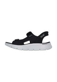 Sandalia deportiva negra con diseño abierto, correas ajustables, suela blanca acolchada y parte superior perforada para transpirabilidad. Notable marca "Go Walk".
