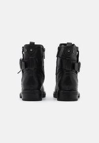 Black leather ankle boots with a round toe, side zipper, buckle accents, and a sturdy block heel. Textured finish detailing on the surface.