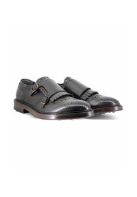 Scarpe in pelle nera con punta rotonda, dettagli decorativi in brogue e doppia cinturini. Presentano una tomaia testurizzata e una suola liscia.