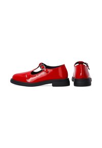 Glossy red leather shoes with a rounded toe, black trim, and an adjustable strap featuring a silver buckle. Low black rubber sole.