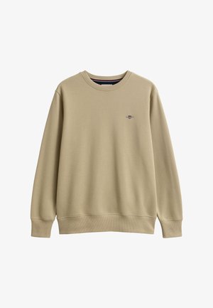 Beigefarbener Langarmpullover mit Rundhalsausschnitt, gerippten Bündchen und Saum, mit kleinem gesticktem Wappen auf der linken Brust.