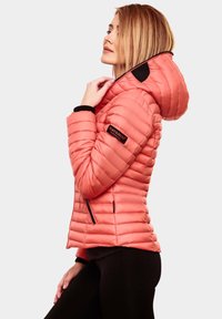 Coral puffer jacket with a hood, featuring horizontal quilting, black accents, and a logo patch on the sleeve. Zippered side pockets.