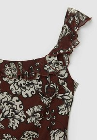 Abito floreale marrone con motivi botanici in bianco e nero. Presenta una spallina arricciata e un tessuto leggero e testurizzato.
