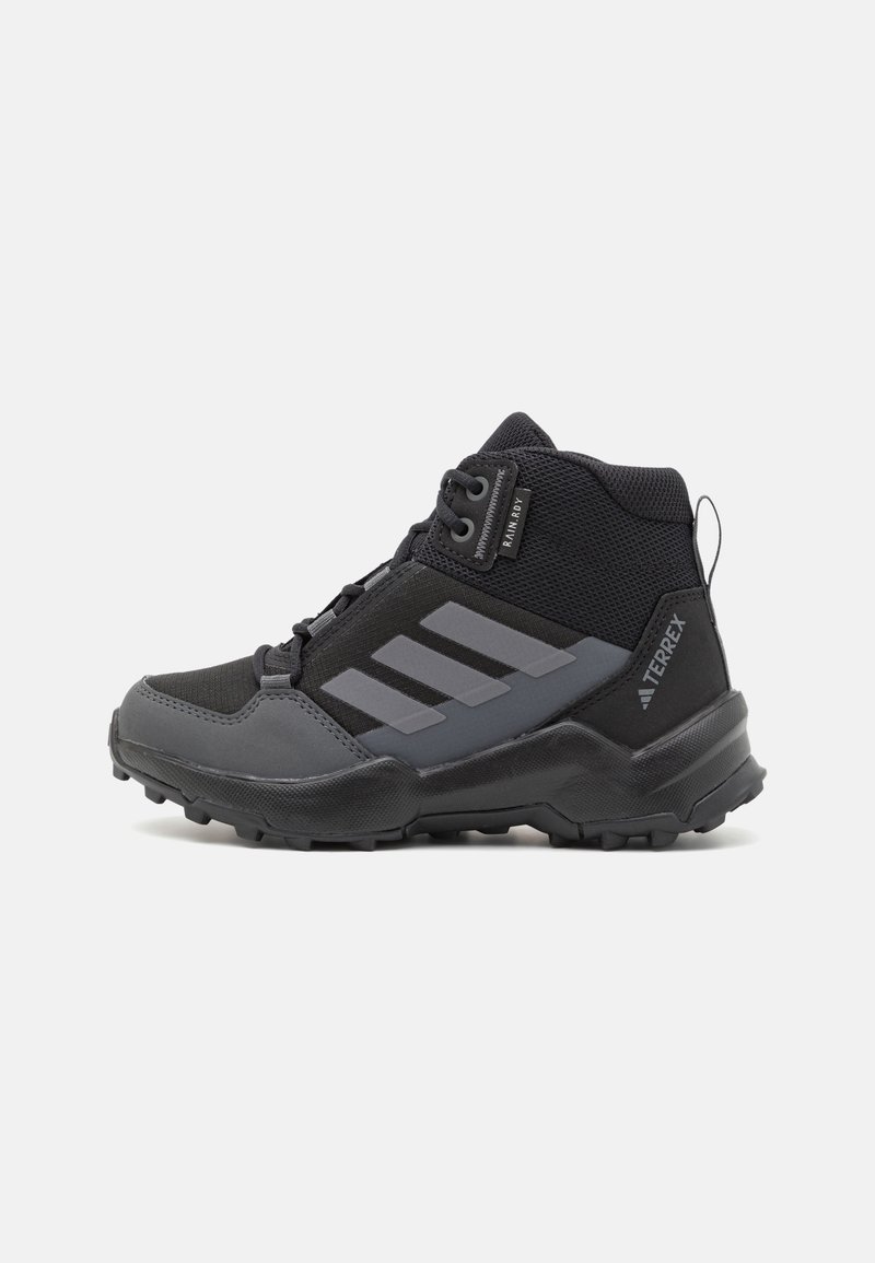 Black high-top hiking shoe with mesh and synthetic material, featuring gray accents, three-stripe logo, and rugged rubber sole for traction.