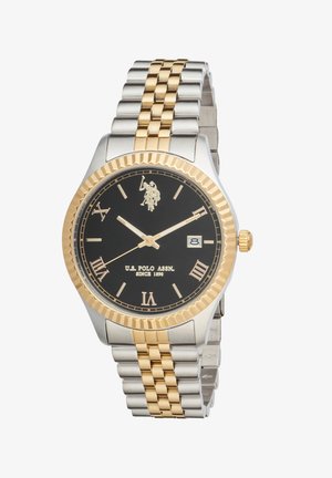 Montre-bracelet pour homme avec cadran noir, chiffres romains dorés, bracelet en métal or et argent, affichage de la date, et logo U.S. Polo Assn. à 12 heures.