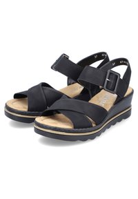 Zwarte leren sandalen met kruisbandontwerp, verstelbare gesp bij de enkel, gevoerde voetbed en een lage wigzool met een gestructureerde rand.