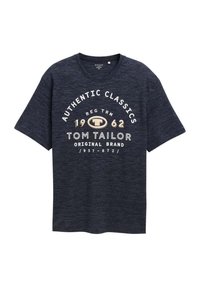 T-shirt bleu marine en tissu texturé avec un texte imprimé en blanc et or : "AUTHENTIC CLASSICS 1962 TOM TAILOR ORIGINAL BRAND."