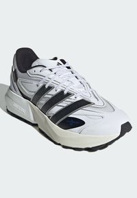 White running shoe featuring a sleek design, textured synthetic upper, black accents, and a cushioned sole with visible logo details.